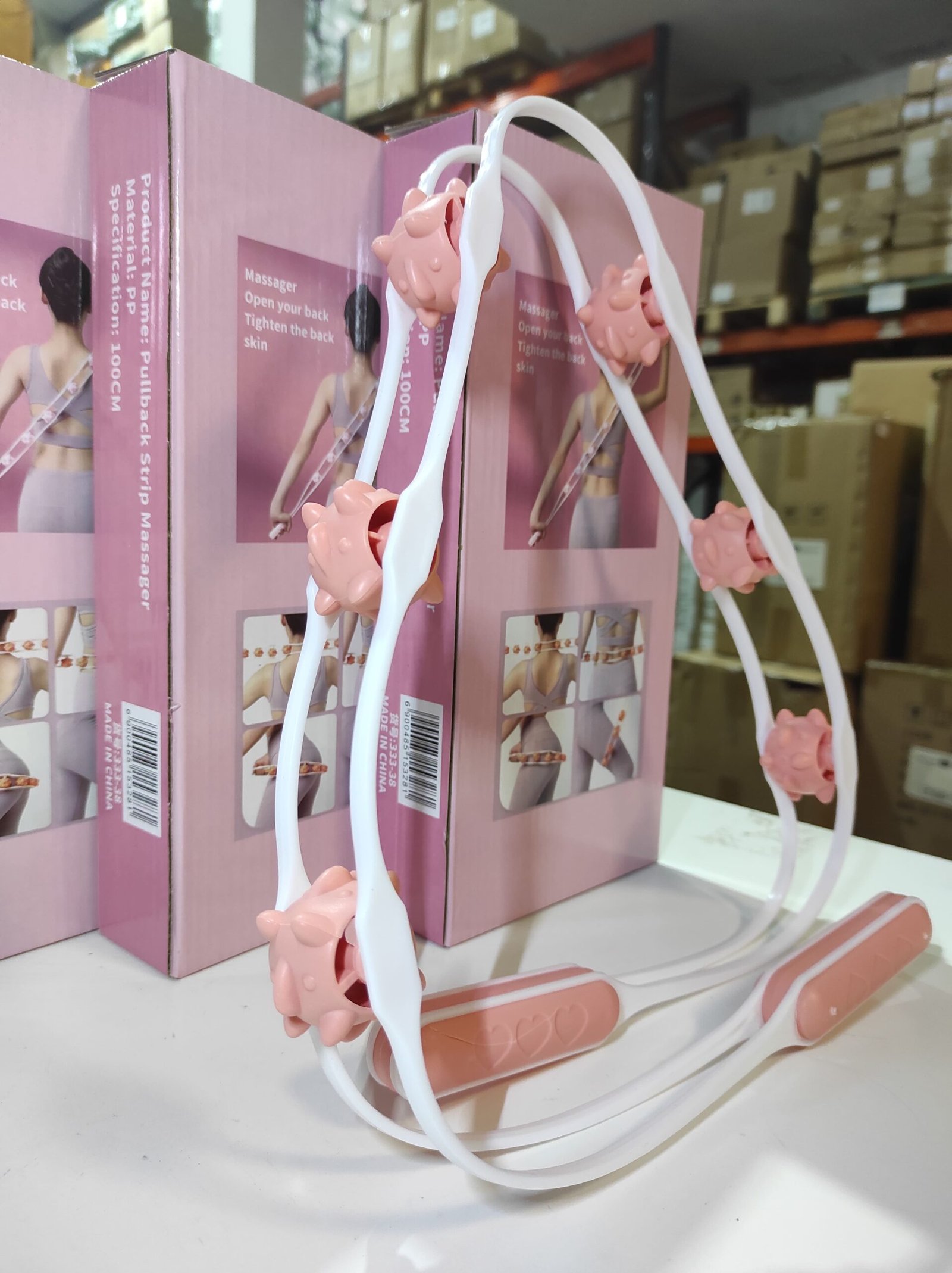 Rodillo manual de masaje corporal con 6 bolas giratorias – blanco y rosa - Imagen 4